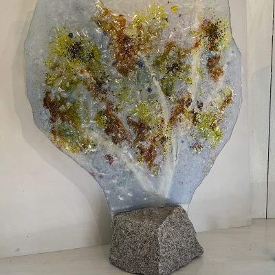 Ulla Hultberg "Höst” Genom glasets genomskinlighet fångar jag naturens färger, skiftningar och ljus. Naturens bridge är ett naturligt tema för mig. Motiv som som vatten, landskap och växlighet fascinerar. Teknik Glasfusing eller glas gjutning format i glasugn. Oftast arbetar jag med vanligt fönsterglas, färgpigment och glaskross. Genom att bearbeta underlaget får jag fram strukturer. Teknik:Glasfusing monterad på sten.